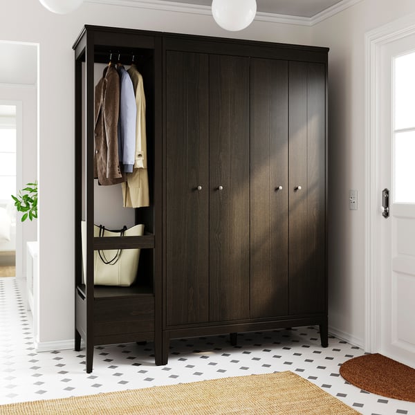 Large brown wooden wardrobe with bifold doors, hanging clothes, adjustable shelves.