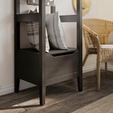 Modern dark wood storage unit with open shelves and drawers, featuring striped cushions.