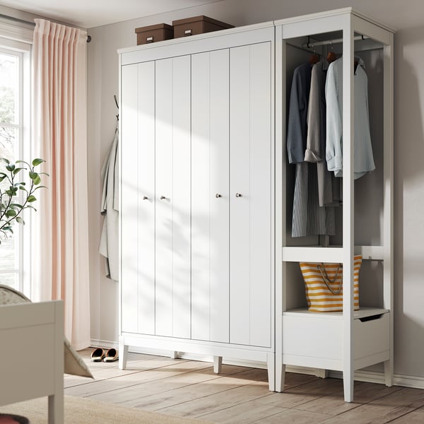Modern white IDANÄS wardrobe with bi-fold doors, adjustable shelves, and hanging space. Chic, practical design for organized storage.