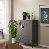 Modern living room with IDÅSEN gray cabinet, white plant, and moon wall art.