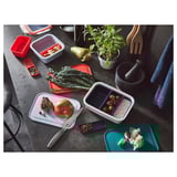 Colorful ikea chopping boards on countertop with foods.