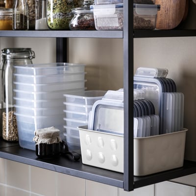 Kitchen shelf with IKEA 365+ containers and utensils.