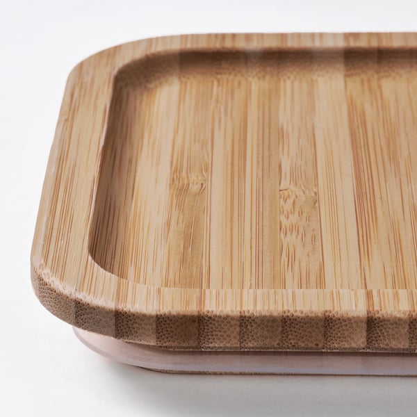 Bamboo lid of durable food container, tightly fitted and well-crafted.