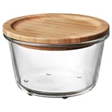 IKEA 365+ glass jar with bamboo lid. Round, clear container with a wooden lid, suitable for storing and serving food.