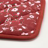 Red floral-insulated mat, detail of stitched pattern and fabric texture.