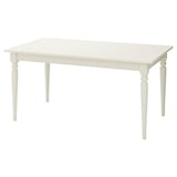 A white, square-shaped, extendable dining table with four turned legs made from solid wood. The tabletop is smooth with a clear lacquer finish.