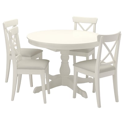White round extendable dining table & 4 matching chairs, sleek design, solid wood, easy-clean surfaces.