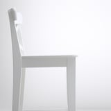 White wooden chair with sleek design, sturdy build.