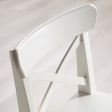 Modern white chair with sleek lines and sturdy wooden frame.