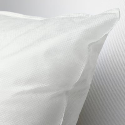 Close-up of soft, white, textured sofa cushion, highlighting its plush, comfortable, recycled polyester filling.