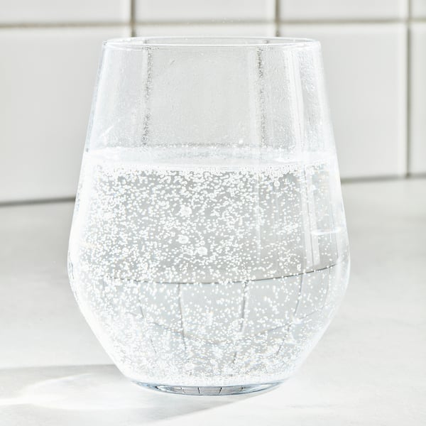 A glass of sparkling water with ice cubes. Refreshing, light, and clear.