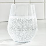 A glass of sparkling water with ice cubes. Refreshing, light, and clear.