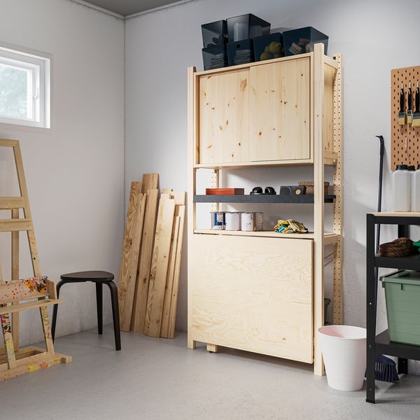 IVAR storage unit with cabinets & shelves against wall.