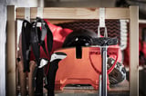 Image shows IVAR storage hooks in black and white, holding ski boots and equipment inside a wooden frame.