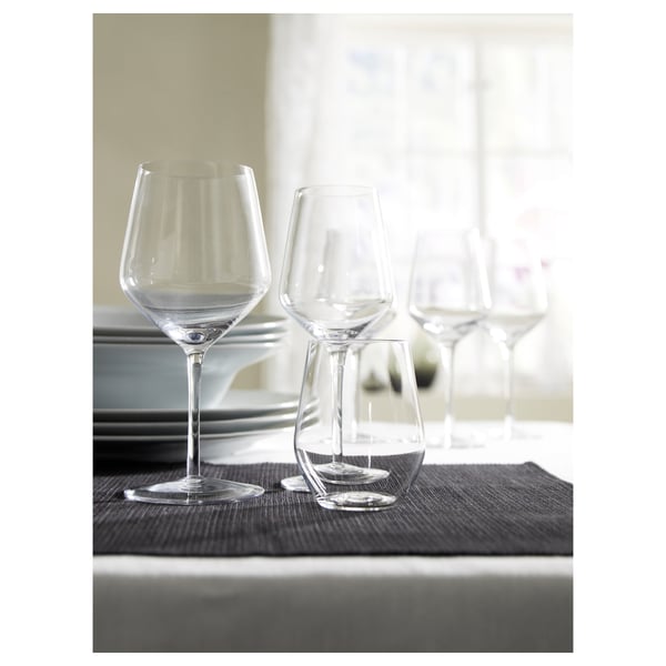 IVRIG wine glasses, clear glass, round bowl, stemmed, set on dark mat, elegant design.