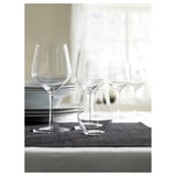 IVRIG wine glasses, clear glass, round bowl, stemmed, set on dark mat, elegant design.