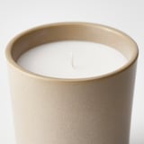 Close-up of JÄMLIK candle in beige jar, unlit.