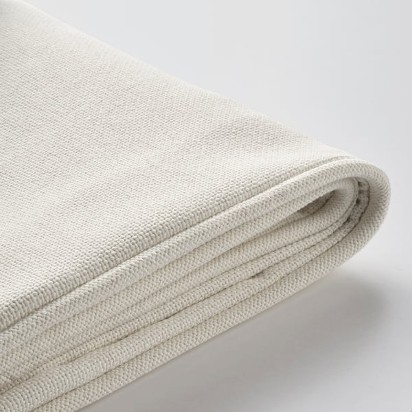 Folded white cushion cover, durable and water-resistant, with soft padded inlay.