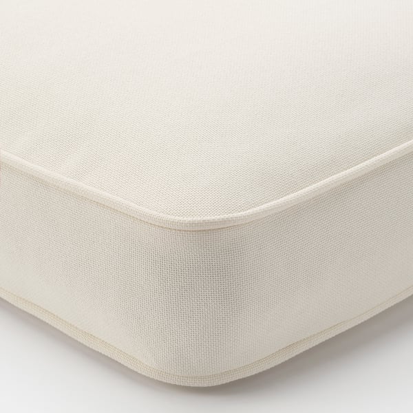 Close-up of high-quality outdoor cushion cover, pristine white, detailed stitching, smooth texture, durable material.