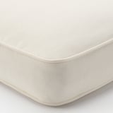 Close-up of high-quality outdoor cushion cover, pristine white, detailed stitching, smooth texture, durable material.