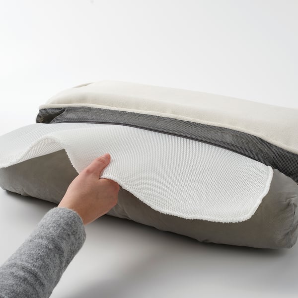 Person holding water-repellent, fade-resistant JÄRPÖN/DUVHOLMEN back cushion with zipper for easy cleaning.