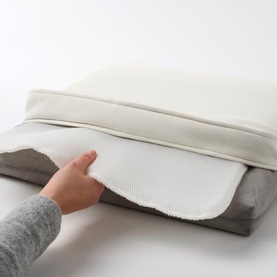 Hand lifting chair cushion. Grey textured cover with white lining, anti-slip dots underneath.