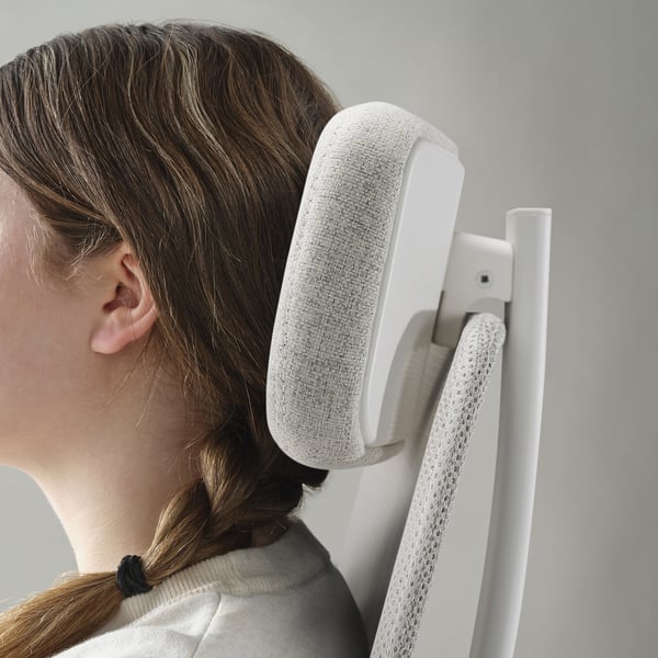 Image shows a person using an office chair with adjustable backrest and armrests. The ergonomic design supports posture and comfort.