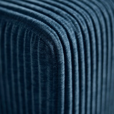Close-up of deep blue, textured corduroy fabric, showcasing quality and comfort of modular sofa.