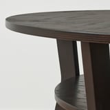 Round wooden coffee table with birch legs and smooth top.