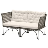 Modern wicker outdoor sofa in gray with white cushions.