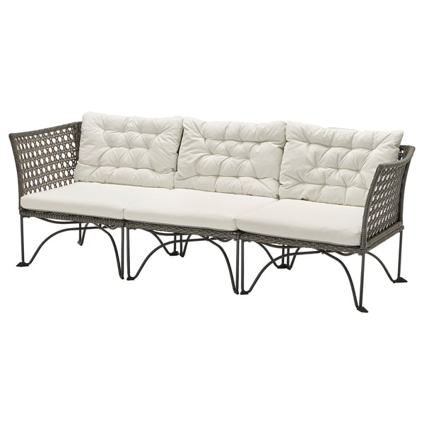 A JUTHOLMEN outdoor modular sofa set, featuring beige cushions and dark grey wicker, designed for comfort and durability.