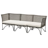 JUTHOLMEN outdoor sofa, gray with white cushions, wicker design, curved shape.