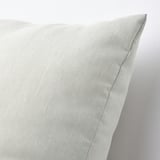 Close-up of a plush, eco-friendly cushion made from recycled materials, showcasing its soft texture and delicate sheen.