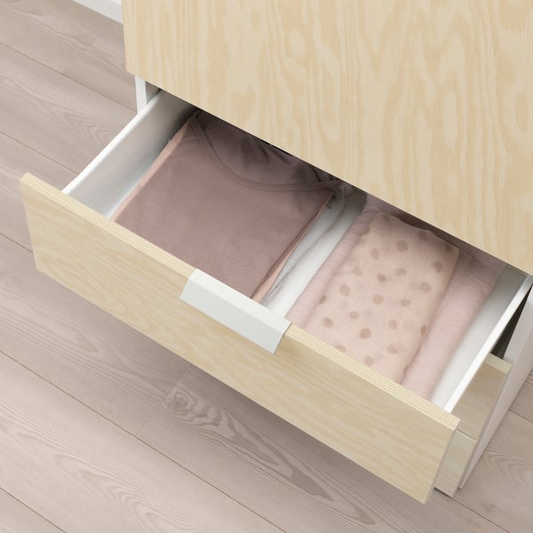 Open wooden drawer with fabric organizer and shirt inside, part of a storage system.