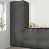 Large dark-grey KALHYTTAN kitchen cabinets in concrete effect. Tall units with metal handles, bigger than nearby plant and countertop items.