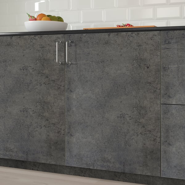 Dark-grey kitchen cabinets with silver handles, topped with fresh fruits.