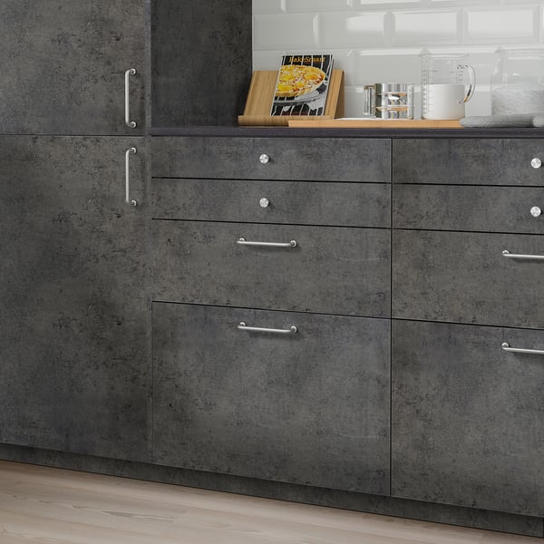 Dark-grey KALHYTTAN kitchen cabinets with concrete texture. Silver handles, four drawers, compact yet spacious.