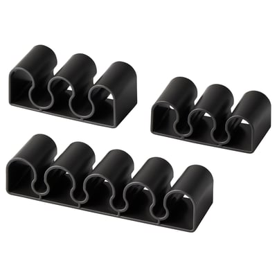 Four black KALKSTUFF cable holders, each with three slots for organizing cords, displayed against a white background.