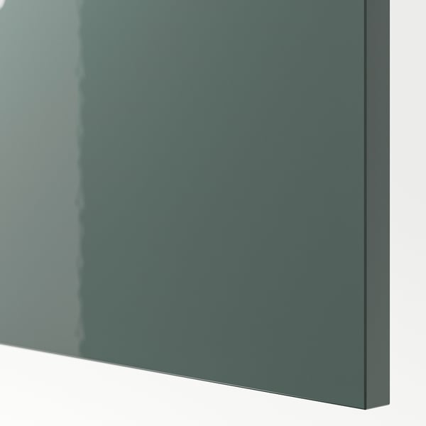 Close-up of high-gloss gray-green cover panel. Smooth, reflective surface, indicating quality finish.