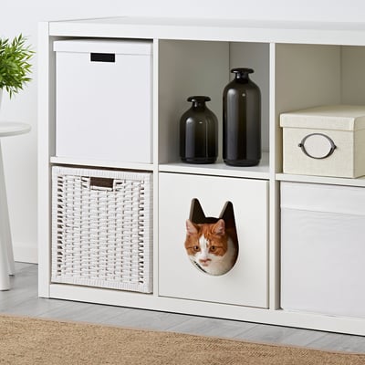 Cat shelf with basket, bed, & vases. Tabby peeks out.