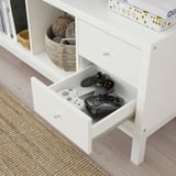 White KALLAX drawer with two game controllers. The drawer is pulled out to show its contents, storage is flexible, fits KALLAX.