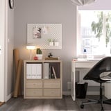 Home office with KALLAX storage; lamp, cactus, window.