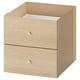 An ikea KALLAX unit with two drawers in light oak finish. It a simple, rectangular design with wooden texture and silver drawer knobs.