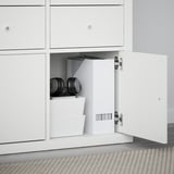 KALLAX storage unit with open drawer showing organized items: weights, boxes.
