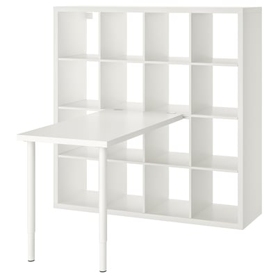 A white ikea KALLAX shelving unit with an attached table top and adjustable legs, designed for versatile storage and workspace solutions.