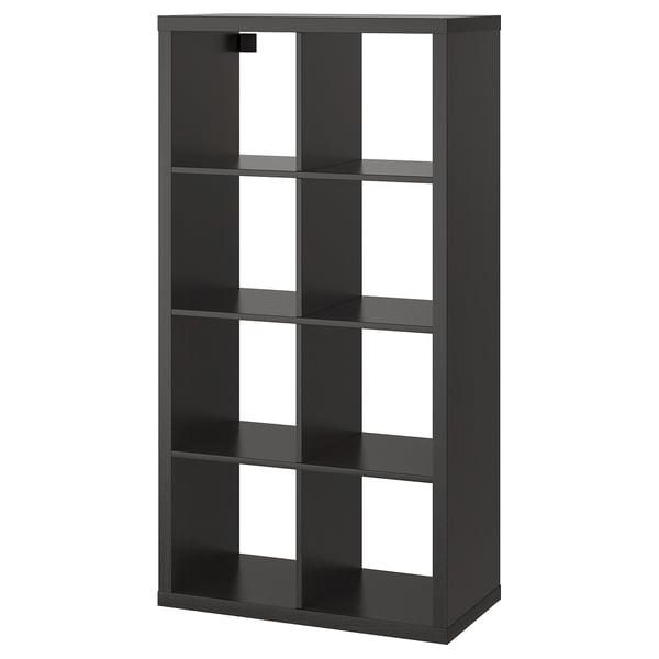 A black KALLAX bookshelf with multiple open compartments, made of particle board and acrylic paint, designed for versatile storage.