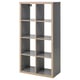 Displays an empty gray KALLAX shelf unit with multiple compartments, featuring a modern and minimalist design.