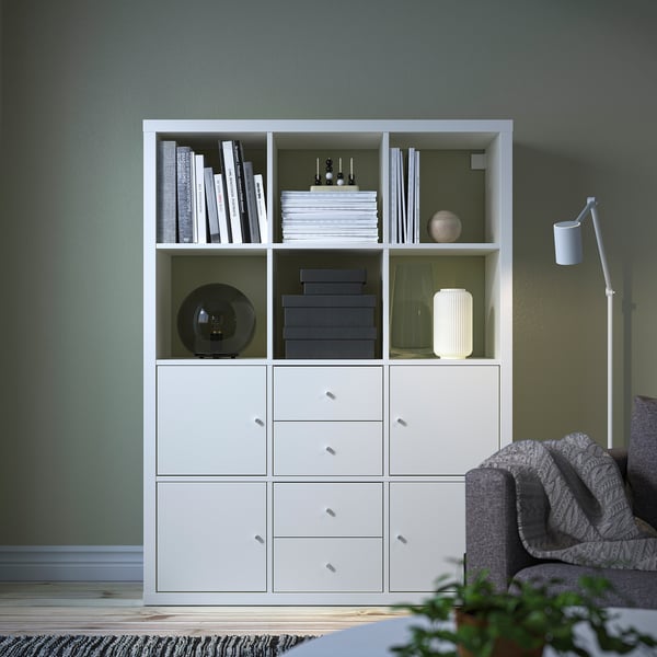 KALLAX shelf unit, large, holding books & storage, dominates room.