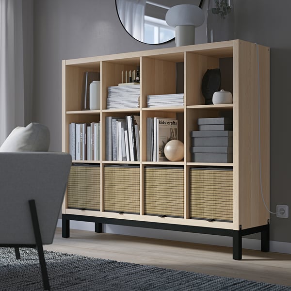 KALLAX shelving in light oak with books and decor, black underframe.
