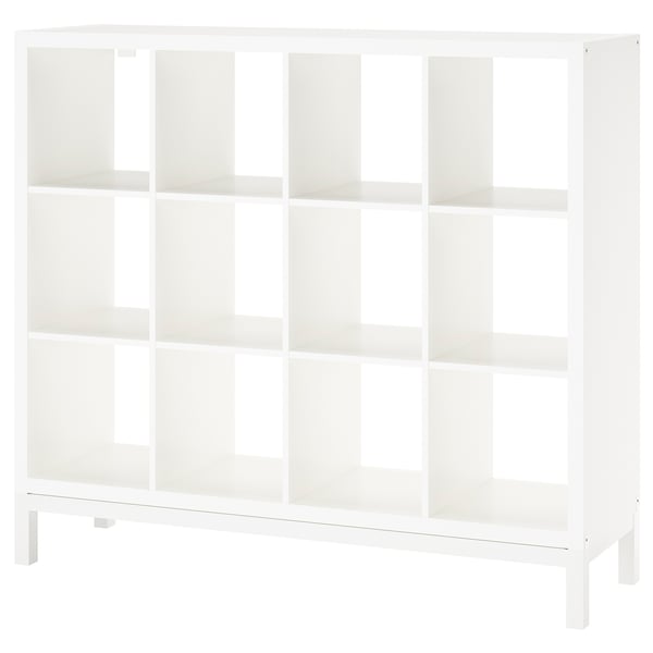 White KALLAX shelf, cubic design, smooth edges, stands on 4 legs, all open compartments.
